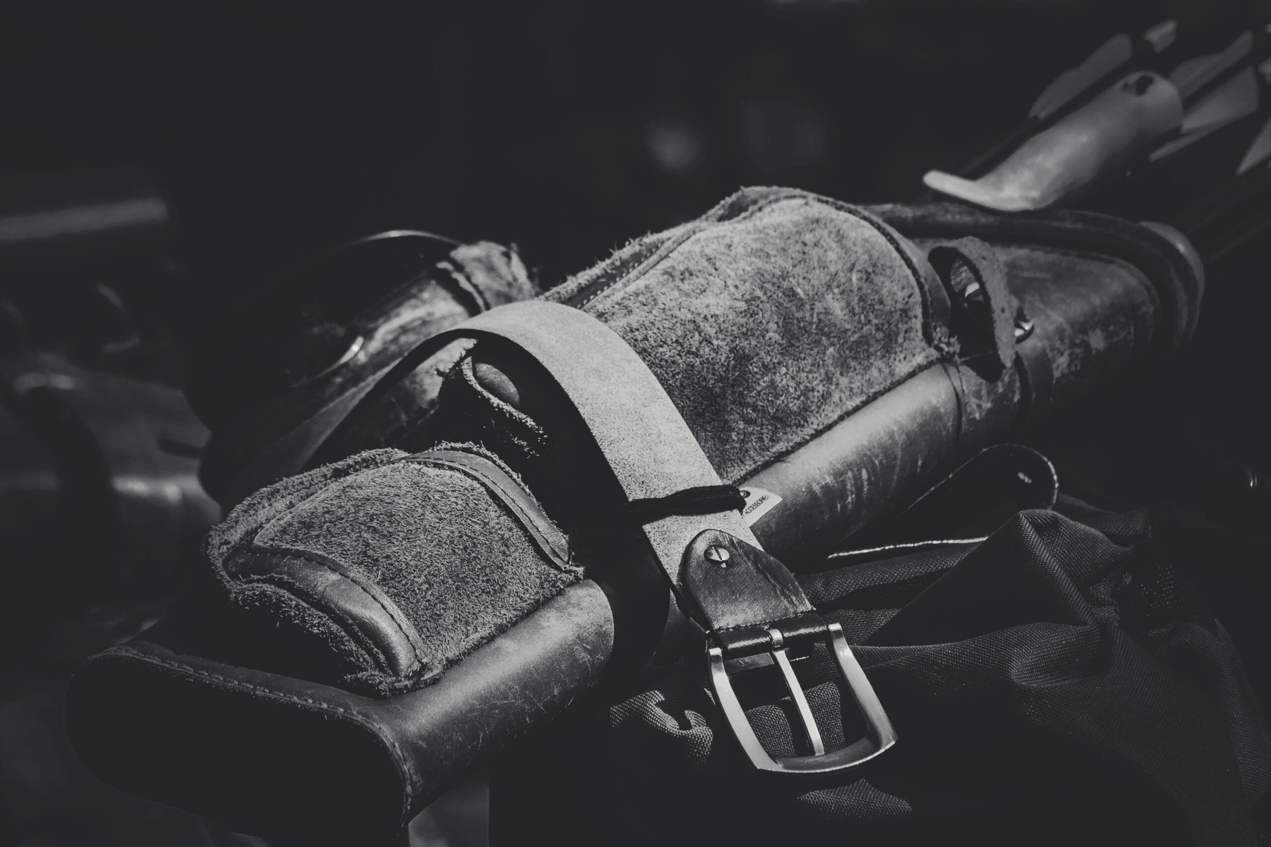 pexels-photo-90638-90638 Detailed black and white image of a leather archery quiver with buckle, emphasizing texture and craftsmanship.